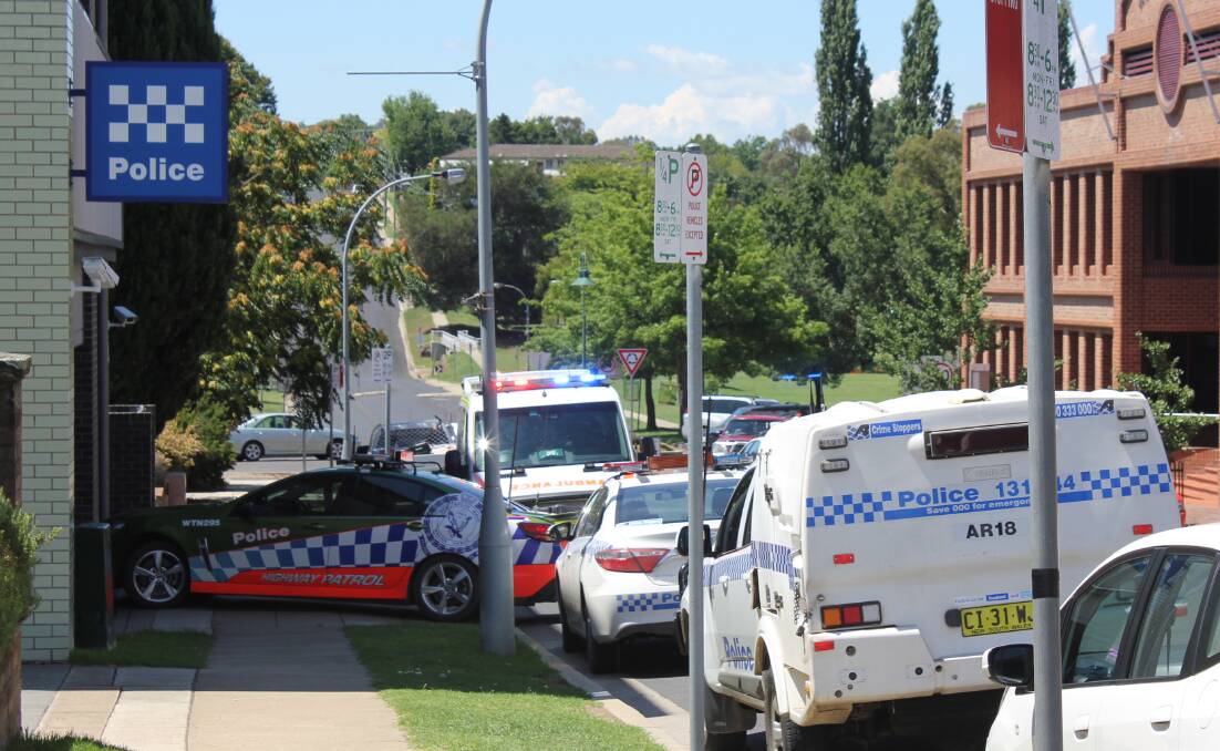 Hospitalised: Paramedics, pictured at the police station, transported one male who was arrested after the Armidale chase to hospital on Tuesday. Photo: Madeline Link
