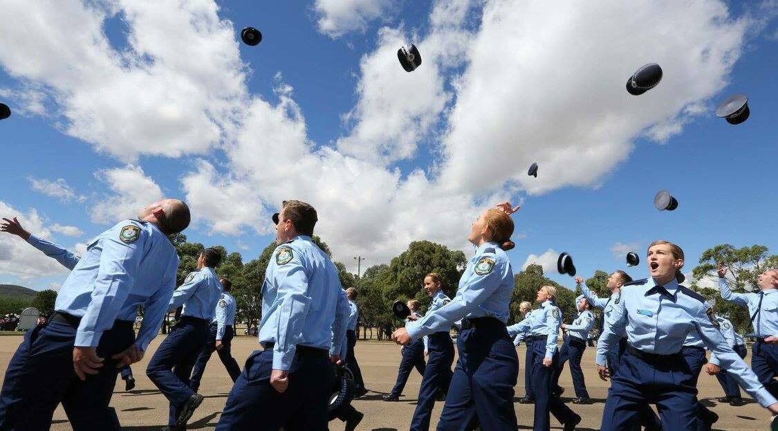 Passing out: Some of the 130 new probationary constables celebrate at their attestation parade in Goulburn at the police academy on Friday. Photos: Nsw Police