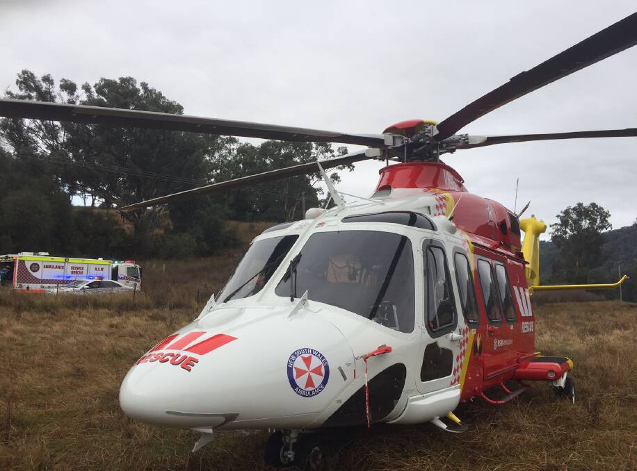 Crash scene: The Westpac Rescue Helicopter landed in a paddock next to Nundle Rd at Woolomin on Wednesday morning. Photo: Westpac Rescue Helicopter