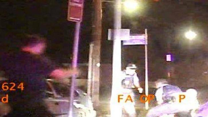 Acquitted: Police in-car video shows Senior constable Christopher Charles Fullick sprint in to join the arrest after he was involved in a high-speed crash at Hamilton on January 27, 2016. Photo: Supplied