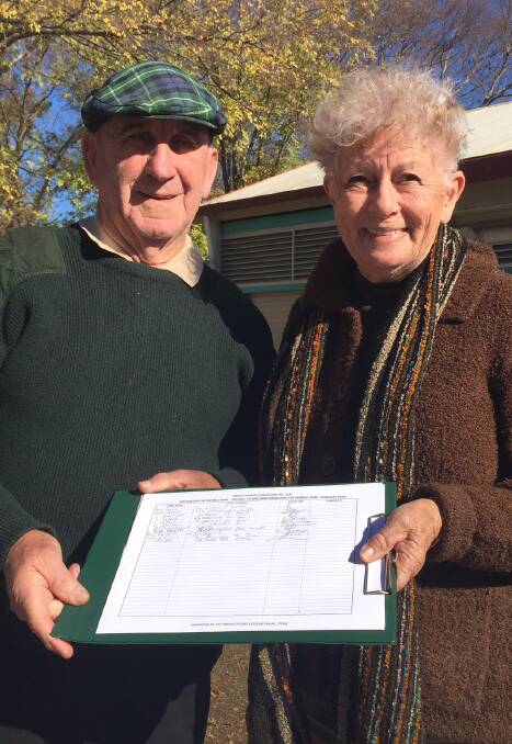 Tingha residents Bernie and Colleen Graham with some of the signatures they have collected calling for the boundary between the shires to change.