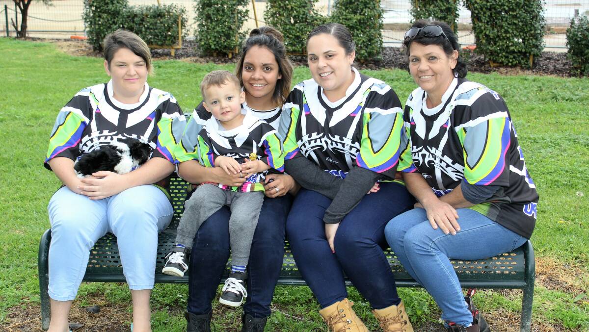 Mitchell Bartram Memorial football game organisers Shay Bartram holding Yaryar the puppy, Cooper Townsend, Sheena Fernando, Holly Bartram and Tracey Bartram show off the brand new guernseys this year, which were designed based on a tattoo Mitchell was planning on getting.