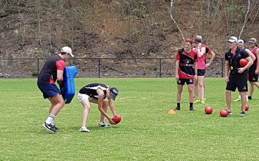 BRIGHT FUTURE: Moree's Jess Maher (with the ball) in training with the Simon Black Australian Rules Football Academy in Brisbane.