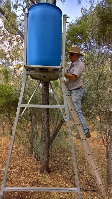 David Walker installing a water stand and Blinky Drinker. Photo: Gunnedah Urban Landcare Group