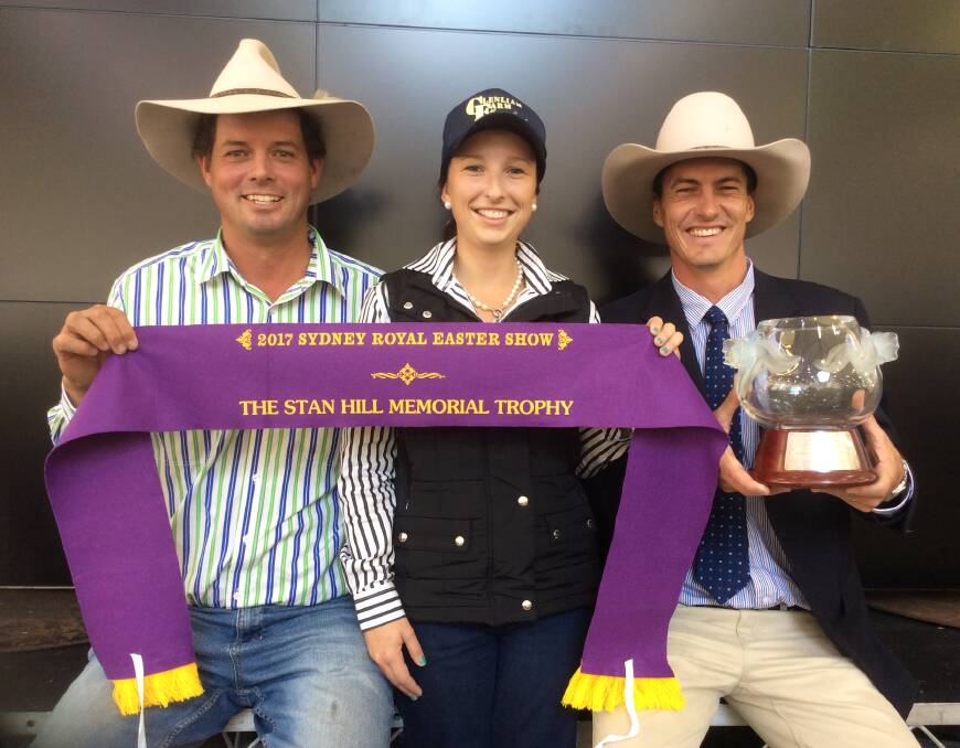 TOPS: Lachlan James and Annika Whale receive the Stan Hill Memorial Trophy and ribbon for their winning three carcases, from RAS cattle councillor Michael MacCue.