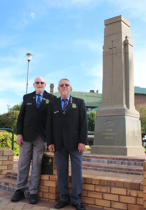 NEW LEADERSHIP: Gunnedah RSL sub-branch's retired president Peter Clarke and new president Peter Kannengiesser at Gunnedah's cenotaph ahead of Anzac Day.
