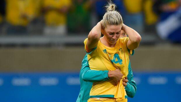 Alanna Kennedy is comforted after missing the final penalty in the Matildas' loss to Brazil. Photo: Pedro Vilela
