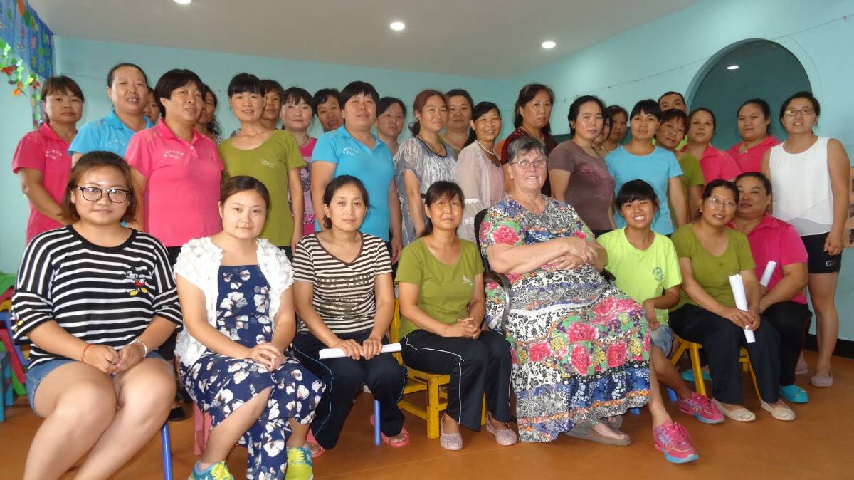 STAFF: Linda Shum, centre front, with most of her staff - nannies who care for children in the Eagles’ Wings Homes, and teachers and aides in the special-needs school.