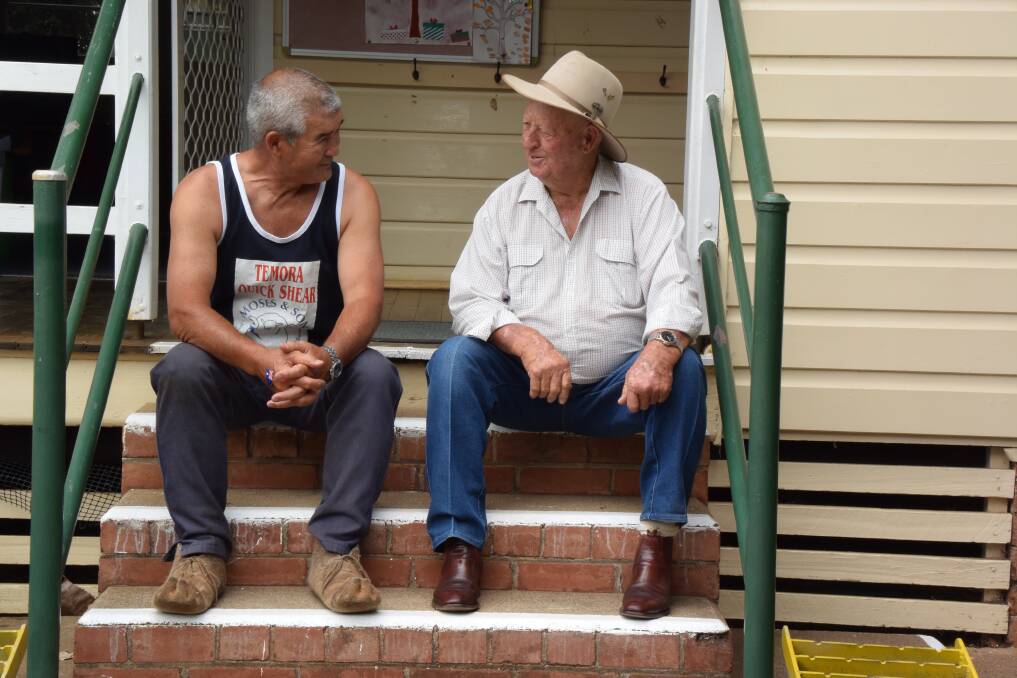 SHARING: Australia Day ambassador John Harper and Nundle man Harry Wiggan trade stories after the local event, held at the public school. 260118CMA34