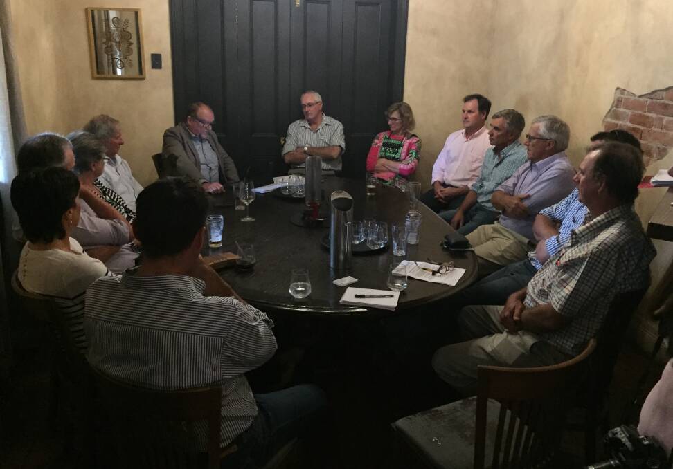 PROGRESS: Creevey Russell principal Dan Creevey, top left, updates about a dozen growers on the latest developments in the shattercane class action.