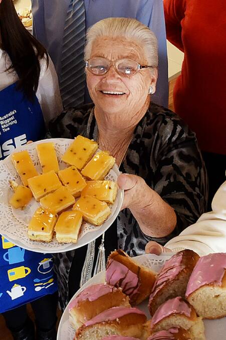 CUPPA GOODNESS: Edna McGrath, pictured here during her 'last' Biggest Morning Tea in 2015, will tie on the apron again this year. Photo: Gareth Gardner 180515GGD01