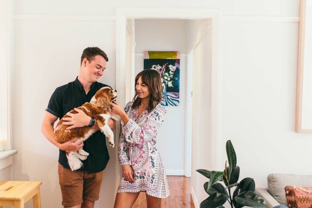 'WE COMPLEMENT EACH OTHER'S SKILLS': Chris O'Connor, Annie Everingham and Max at home. Chris's parents have owned and run businesses formerly in Tamworth and now with him in Newcastle, and he studied commerce at university, which Annie says 'all contributes to the smooth operational side of my business'. Photo: Lazy Bones Photography