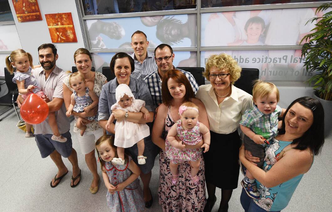 HAPPY FAMILIES: Dr Mark Livingstone (back), nurse Rhonda Ward (third from right) and the Cwach, Lewis, McClelland and Grayson families. Photos: Gareth Gardner 011216GGC08