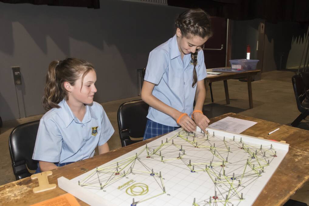 STRATEGY: Tiffany Allones and Jessica Drysdale of Tamworth High School plan their rail network during the discovery day at TRECC today. Photo: Peter Hardin 200318PHB073