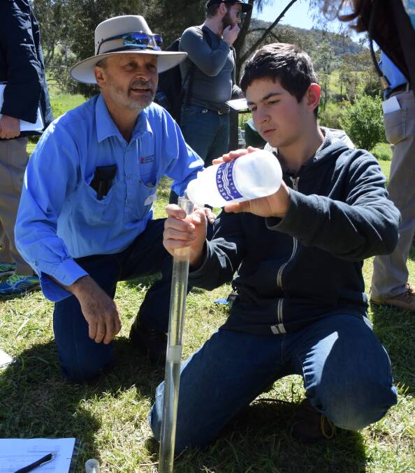 TESTING TURBIDITY: North West LLS senior land services officer Tim Watts and tour participant Kyle Warner. Photo: Carolyn Millet 191016CMA16