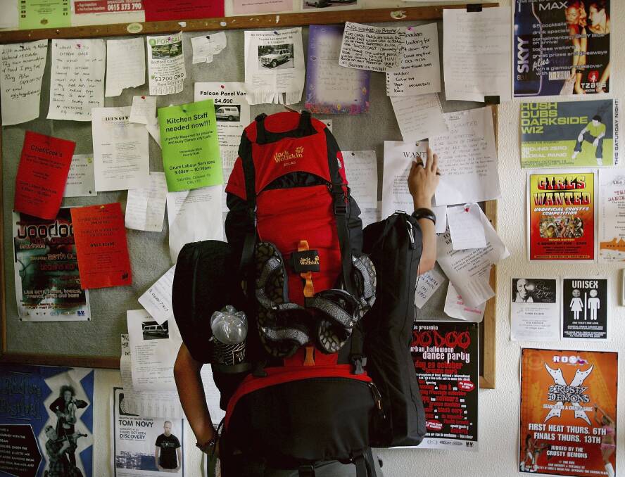 TAX FEARS: A backpacker checks a noticeboard at a hostel. Stakeholders in the New England North West are among 1700 to have made a submission on a review of the 'backpacker tax'. Photo: Ian Waldie/Getty