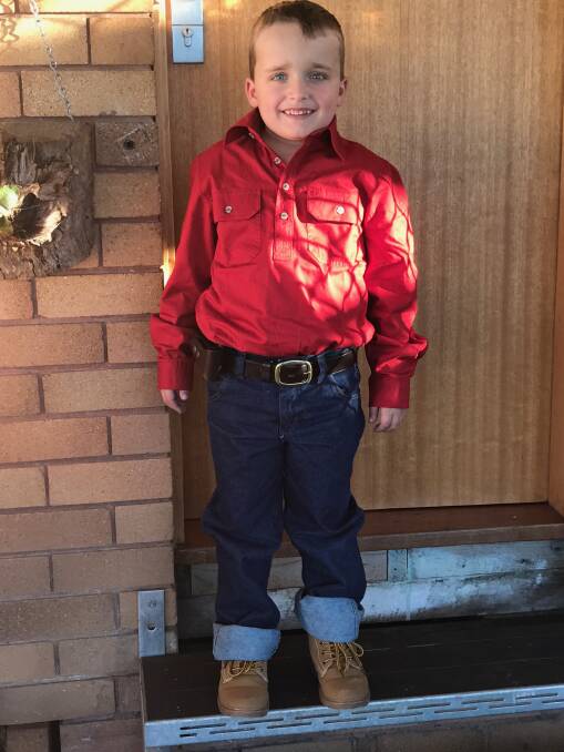 READY TO GO: Kaiden Mood ready for a day on a family friend's farm, where he loves helping his Uncle Pete go hunting and do farm work.