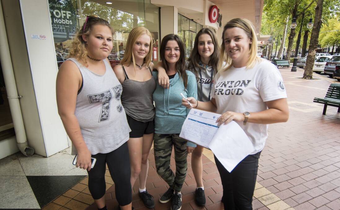 WILLING: Australasian Meat Industry Employees' Union representative Amanda Harvey (right) with Tleigha Matthews, Jessica Kingdom, Reanna Cooper and Shanae Patterson, some of those who put their name to the list. Photo: Peter Hardin 140318PHB043