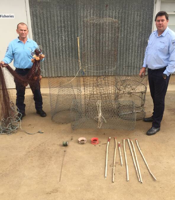 HAUL: Fisheries officer Ron Smith and district fisheries officer Brock Mathers with  confiscated fishing nets and equipment, after a DPI compliance operation.