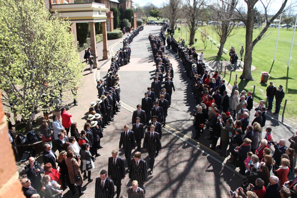 CLASS of 2016: The Year 12 TAS students processing through the guard of honour into the hall on their last day - Jacob is front left.