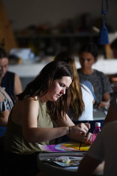 CREATIVE SPLASH: Phoebe Jane works with colour during Annie Everingham's art class on Wednesday.  Photo: Gareth Gardner 290317GGD01