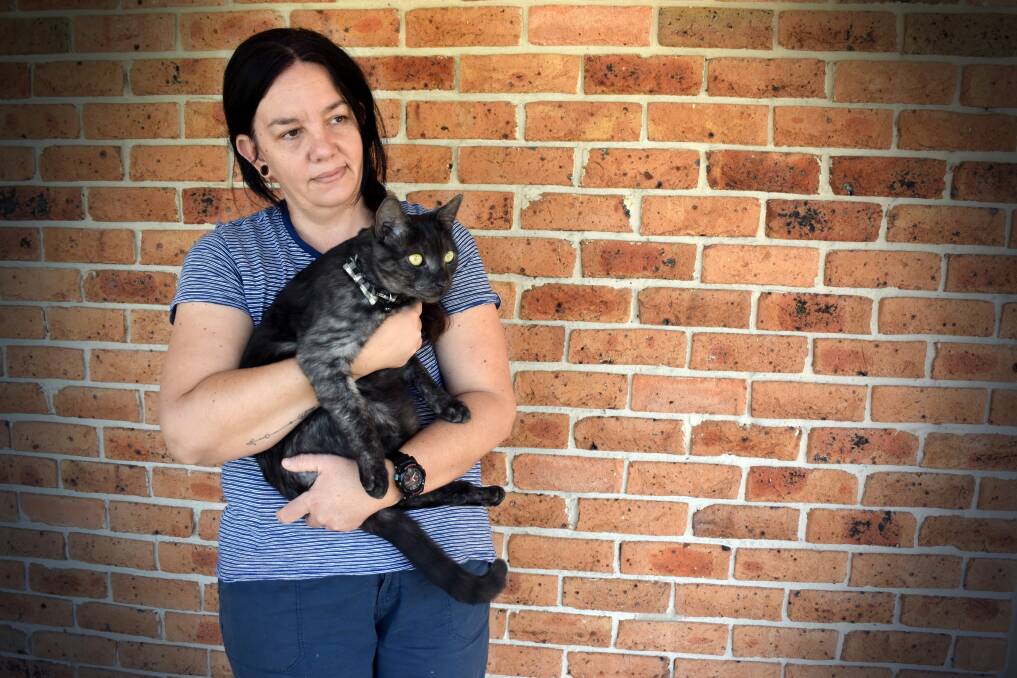 SICKENING: Rebecca Stewart and her domestic shorthair cat, Blue, who returned with grotesque injuries after having been missing for five days. Photo: Carolyn Millet