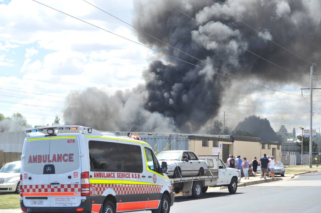 Firefighters battle a fire at a business in William Street. Photos: JUDE KEOGH