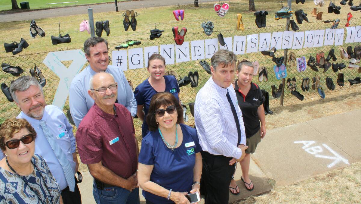 Gunnedah Shire Council, Gunnedah GoCo Community Care and Salvation Army representatives launch the "In their Shoes" #gunnedahsaysnotoviolence display outside Kitchener Park.
