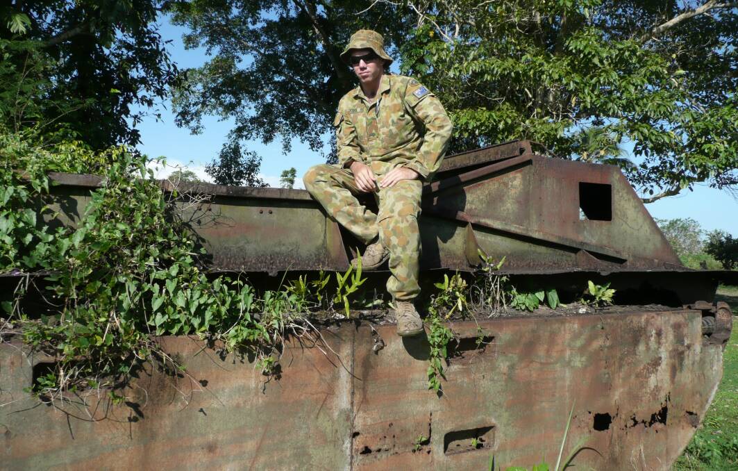 New perspective: Fairfax Media senior journalist Sam Woods pictured with a relic of war during his Australian Army Reserve service.