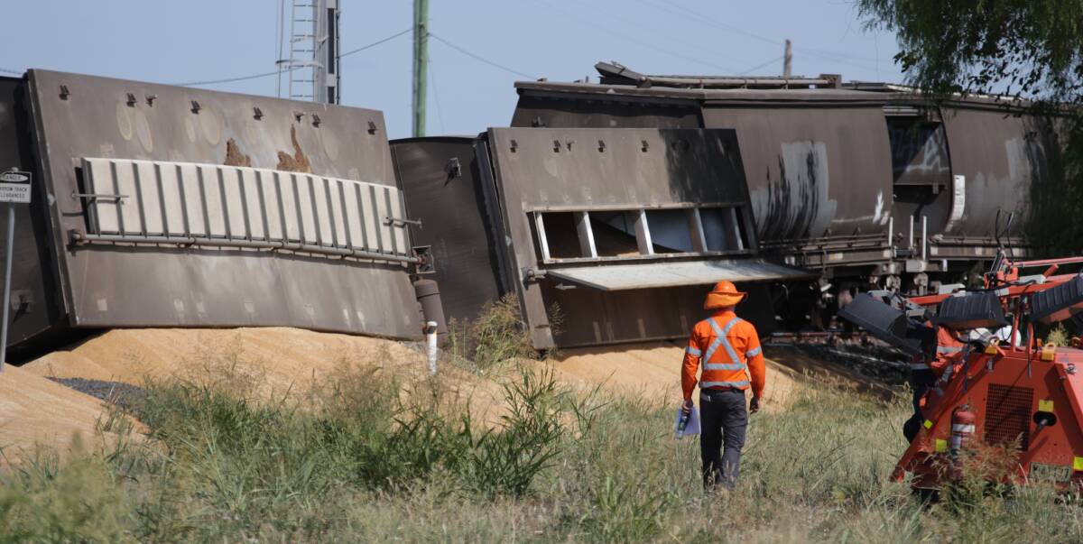 Wrecked: A worker inspects the scene of the grain train derailment at Emerald Hill where six carriages came off the rails on Monday. Police did not report any injuries, however recovery was still under way on Tuesday. Photo: Sam Woods
