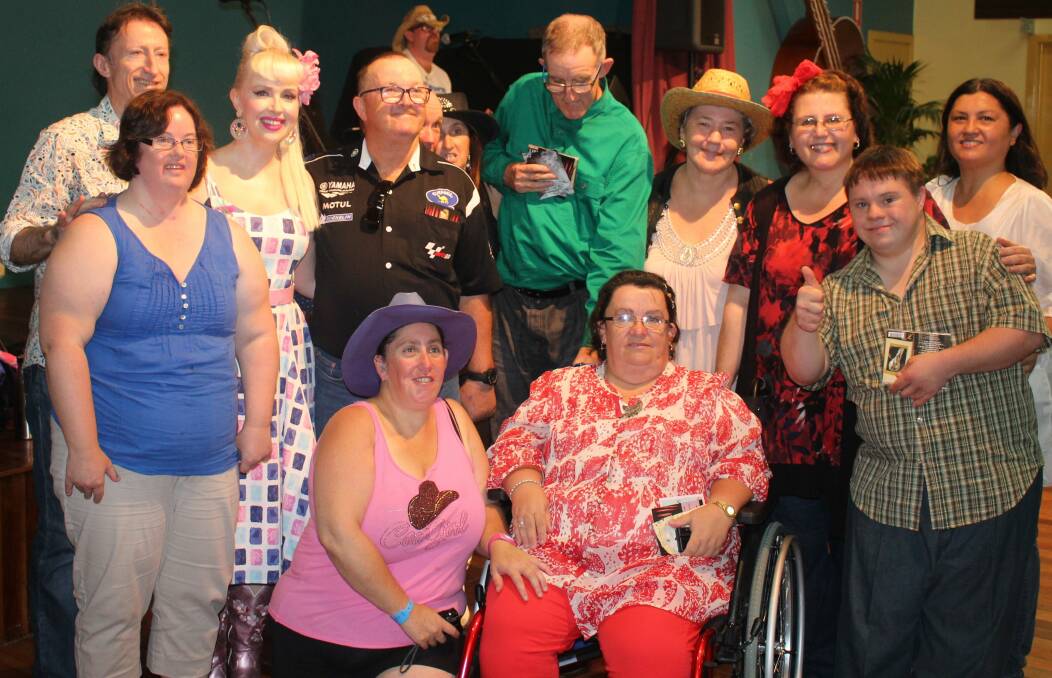 Top performance: Artists Lawrie and Shelley Minson (left), Carolyne Morris and Patricia Cruzado (back right) with Paul Bonner Jones on stage with happy clients at this year's Kooty Country Bash.