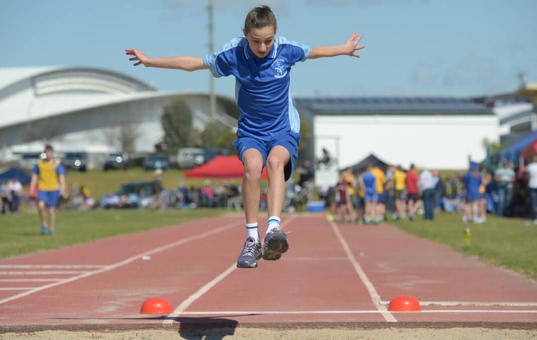Evelyn Bower soars through the air during the long jump event at the Tamworth Athletics Complex.  Photo: Peter Hardin 190816PHC21