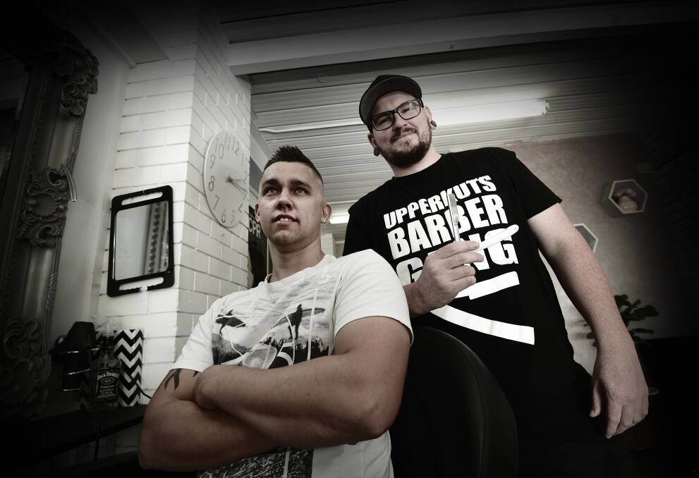 Razor gang: Levi Butcher checks out the fresh cut and shave that Tamworth barber Anthony Cotter just laid down as he practises for next month's Cut Throat Barber Wars in Sydney.  Photo: Gareth Gardner 190417