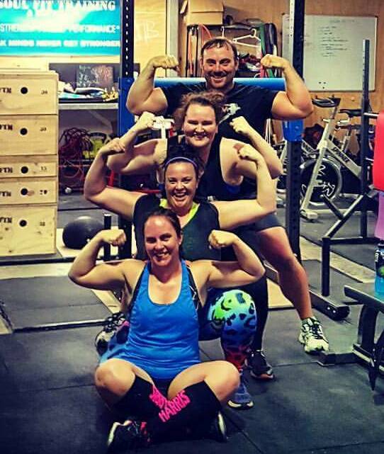 Guns out: rainer Jay Ramirez with Tamworth strongwoman trio Melissa O’Connell, Kat Mackie and Madii Corey as they prepare for the Tamworth tournament. 