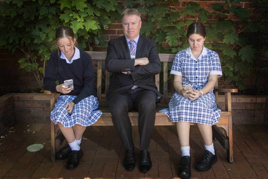 Disconnected: Principal Dave Smith has hung up the phones for all students under year 11, including Isabella Cameron and Tamar Liebensen.
