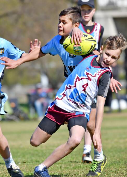 Final touch: North West defender Sean Collins just gets to a runaway Mackillop attacker Sam Graziani-Young as the PSSA touch carnival hits finals today.