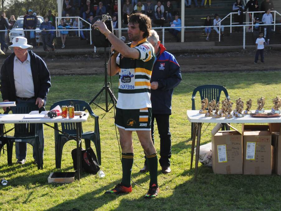 Best on field: Steve Eveleigh collects his Player of the Final award after starring in the Roos grand final win over the Tigers in Manilla. Photos: Liam Hauser