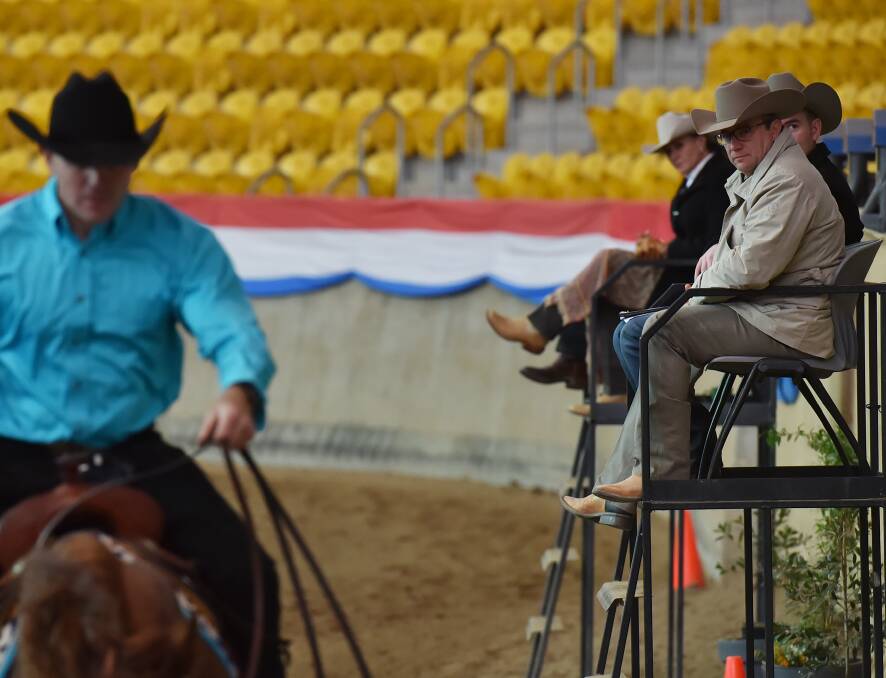 Judging: The international judging panel watch on closely as this horse and rider go through their paces at the Reining National Championships.