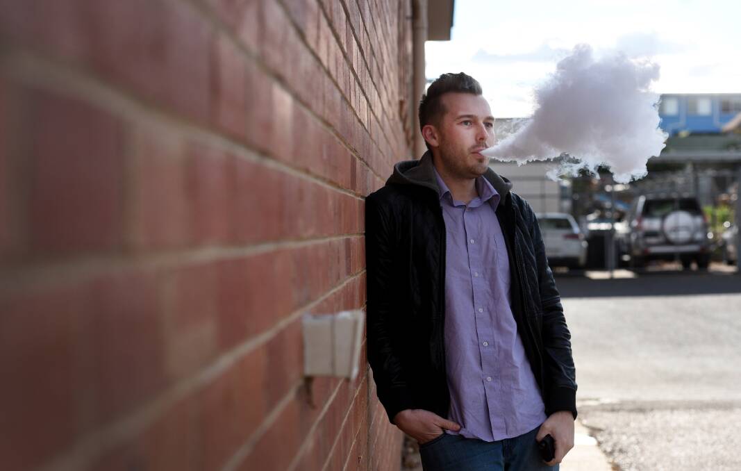 Up in smoke: Nick Grimes used an e-cigarette to quit smoking, and wants all Australians to have the same option. Photo: Gareth Gardner 310517
