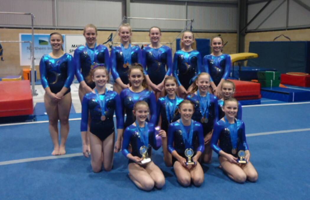 ALL SMILES: The Tamworth Gymnastics Club took 14 girls to the state championships and came home with three winners and 16 apparatus medals.