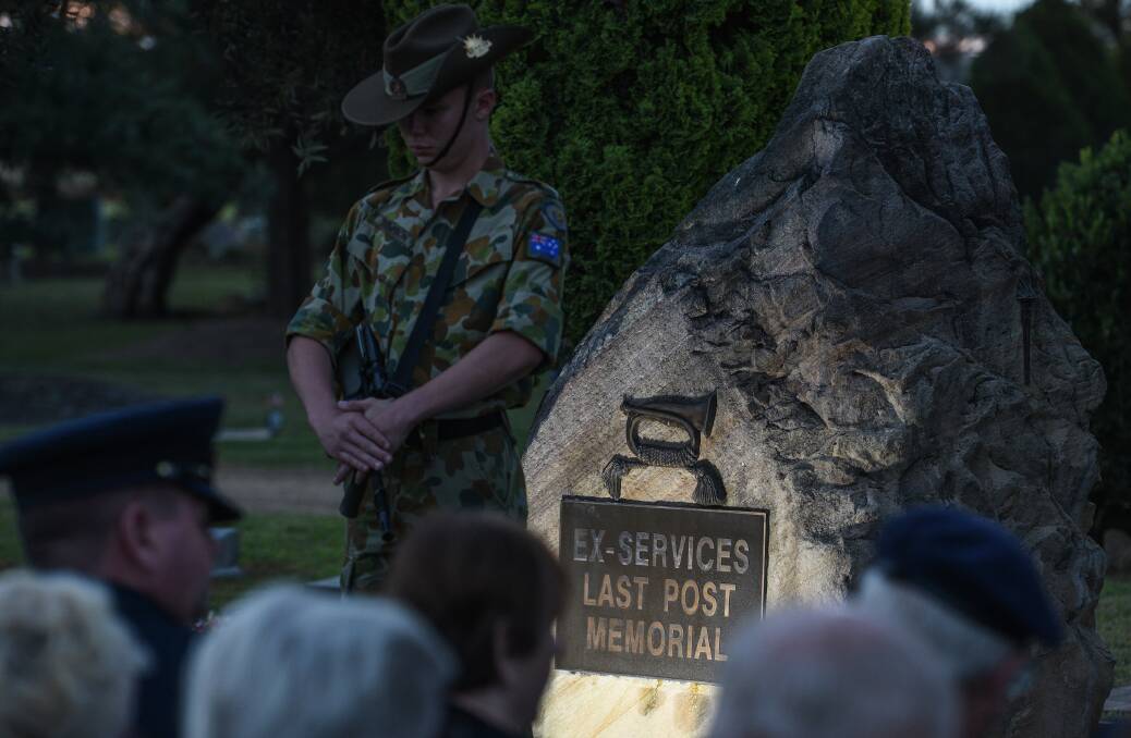 Solemn service: A lone soldier standing guard during the region's first ANZAC service at the Last Post in Lincoln Grove cemetery. A Lone Pine was also planted during the service. Photo: Gareth Gardner