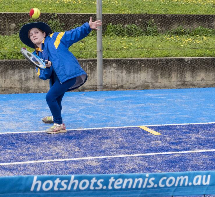 Balanced: Lily Dawe watches this forehand off the racquet and over the net during the Todd Woodbridge Cup modified tennis day at the Tamworth Tennis Club at Treloar Park. Photo: Peter Hardin