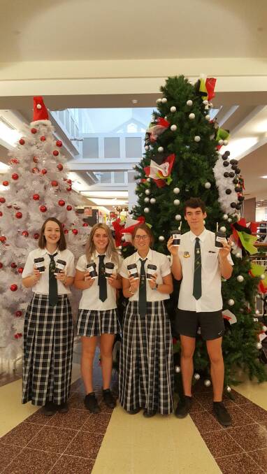 Good will in a cup: Peel High senior leaders Ania Braiding, Mikala Ellis, Lily Gregory and Alex Jenkins making random acts of kindness at Shoppingworld on Friday. 