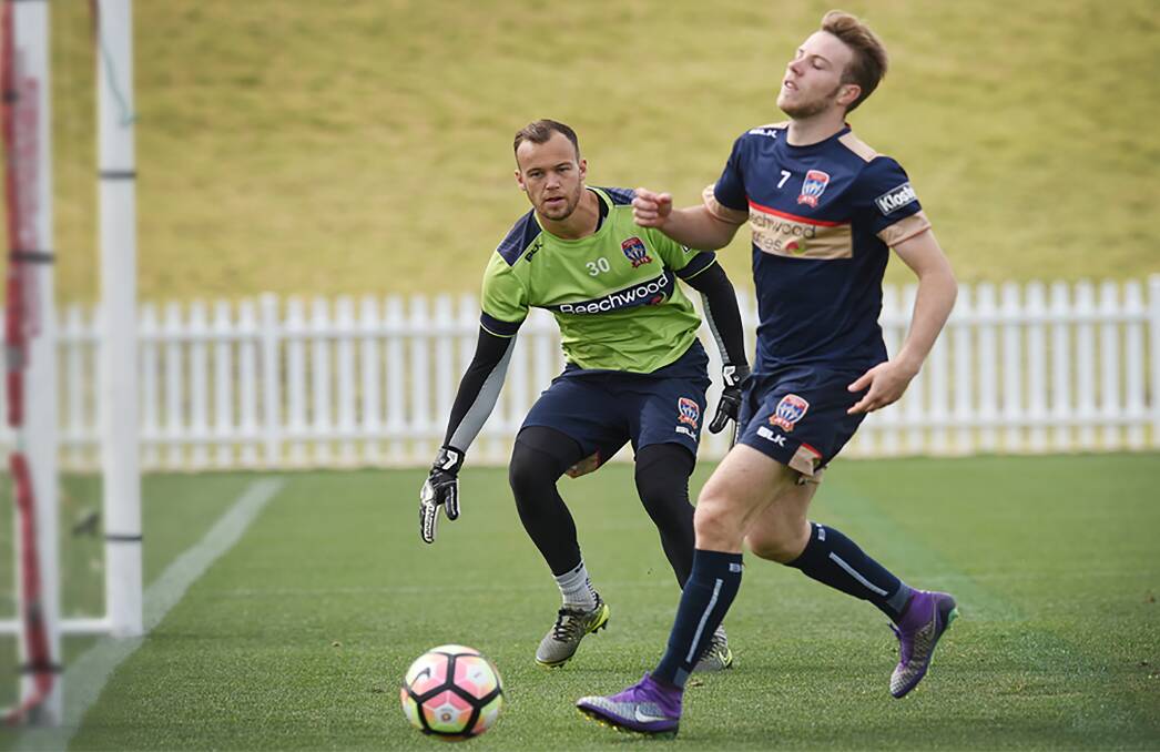 First look at Scully: Jets player Andrew Hoole looks for the net with goalkeeper Jack Duncan watching on as the Jets prepare for Saturday's clash against the Mariners.