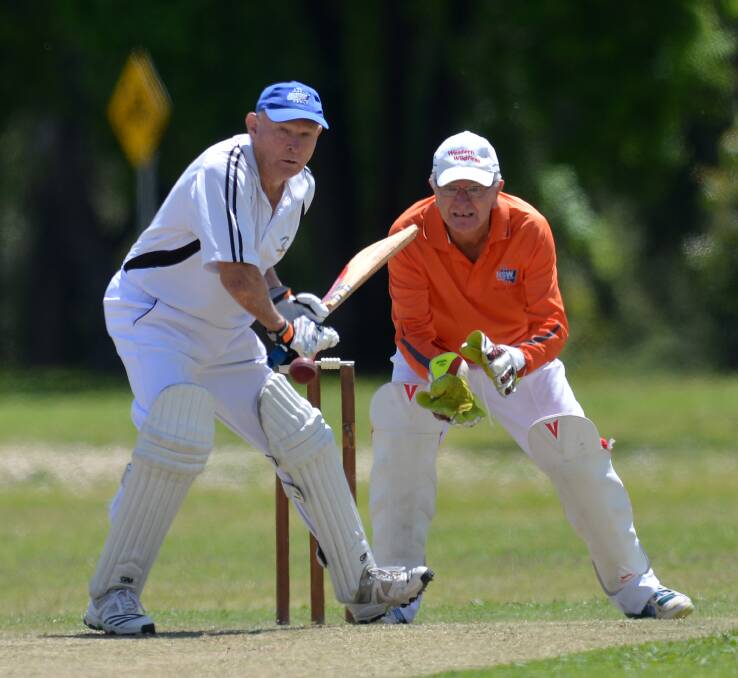 Runs: Tamworth's Doug Truman rocks on to the back foot as he picks a line between Western Wild Fire fielders at the Veterans State Championships this week. Photo: Gareth Gardner 181016GGC13
