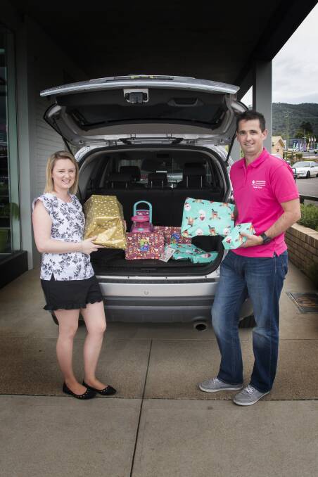 Challenge accepted: Amanda Pearson and Nathanael Sharples have been packing presents all week into the Challenge Santa wagon and delivering them all over the region to kids in out-of-home care. Photo: Peter Hardin
