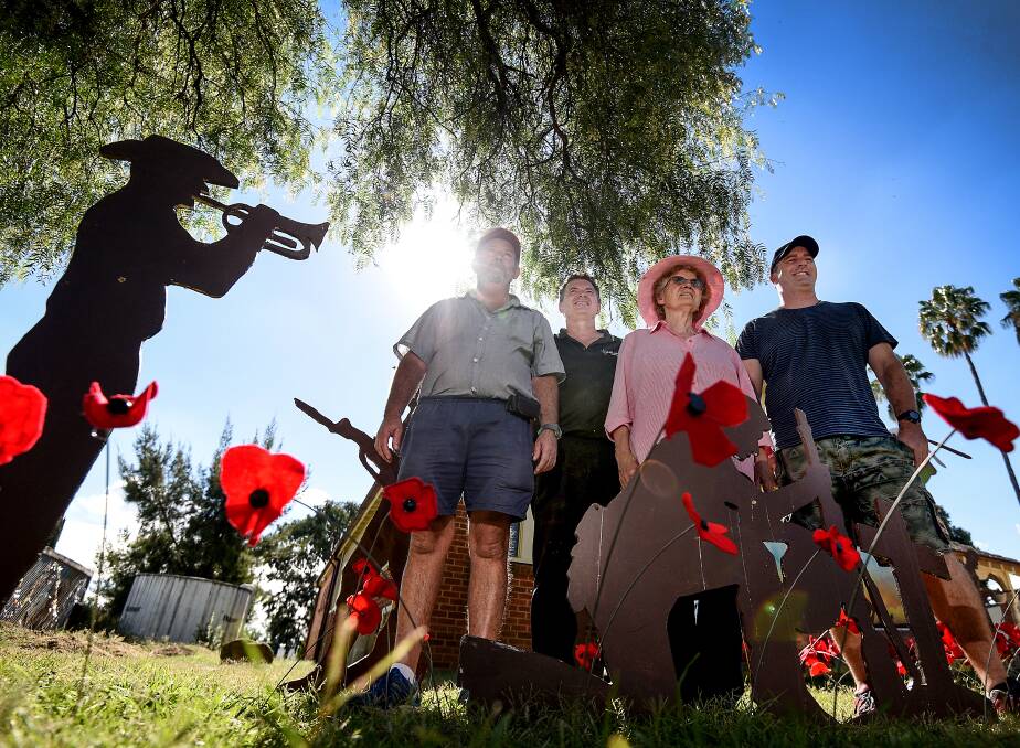 Poppies and passion: Evan Legge, Michael Herden, Pam Crane and Dane Talbot proudly display the Anzac Day tribute at Billabong Clubhouse. Photo: Gareth Gardner