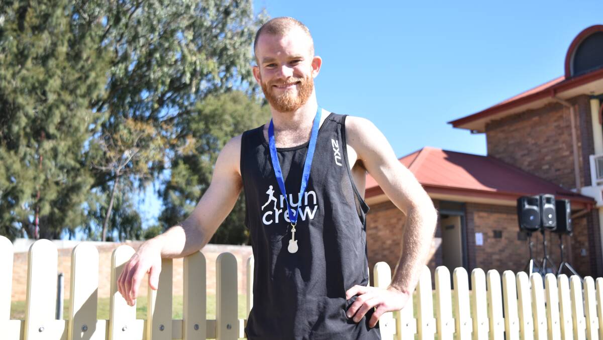 TRIUMPH: Keith Macpherson savours the moment after taking out the half marathon at the Tamworth Running Festival. Photo: Ben Jaffrey