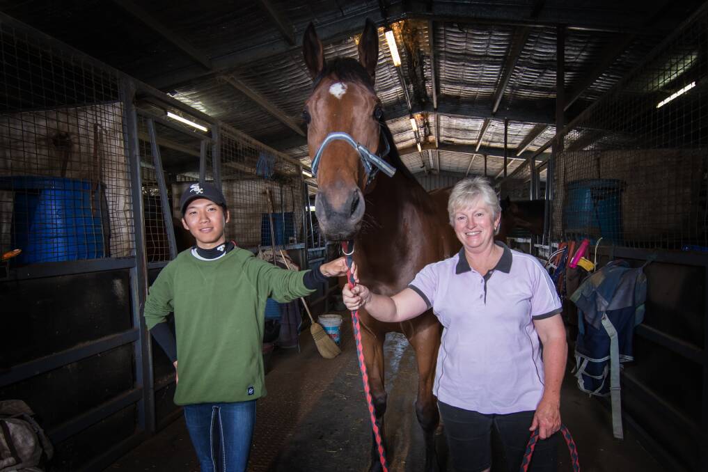 WINNING COMBINATION: Hyosik Lee and Sue Grills at Grills' stable at the Tamworth track. Photo: Peter Hardin