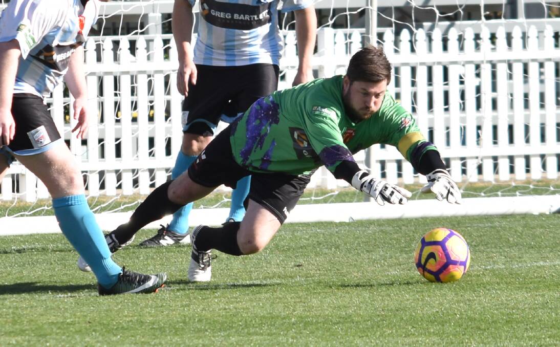 OUTSTRETCHED: Tamworth FC goalkeeper Troy Osborne pounces on a ball during last year's Northern Inland Premier League competition. Photo: Ben Jaffrey